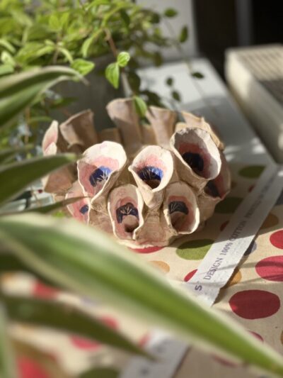 Handcrafted multi-aperture ceramic tulipiere vase hand-painted with pink and purple floral patterns.